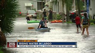 Neighbors kayak through flooded streets in Largo