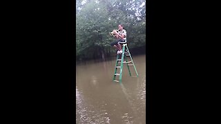 Man plays flugelhorn amidst flooded waters