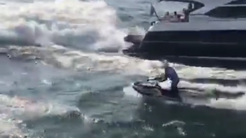 Jet skier performs insane stunt off mega yacht wave