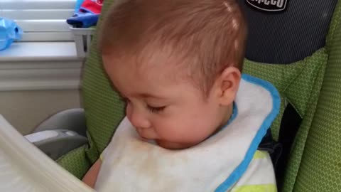 Cute Baby makes a funny face eating his food