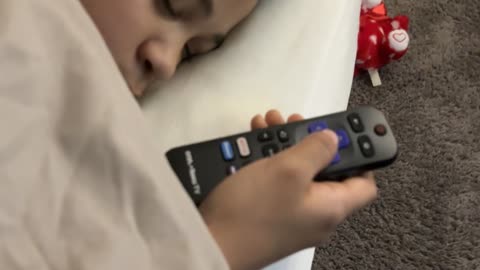 This kid sleeps with remotes #viral