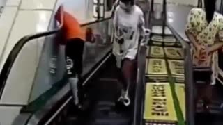 Boy gets stuck between escalator and wall