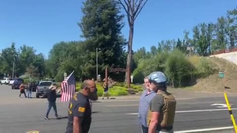 Proud boy takes down signs of protestors in Portland