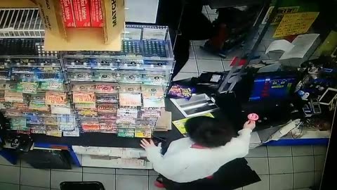 Cashier girl is using mobile phone while dealing with the customer