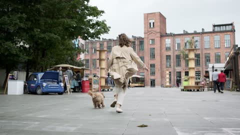 A dog running with its owner