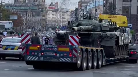 Ukrainian Soldier watching Russian Tank being towed