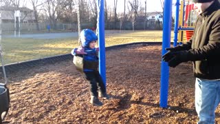 Baby Doesn't Like Daddy Pushing Him On The Swing