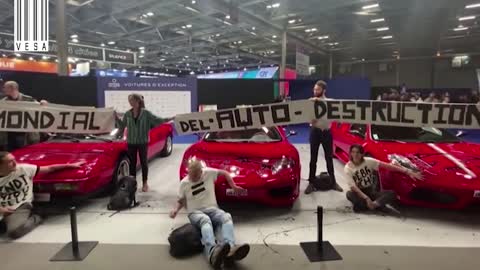 Activists glued themselves to Ferrari supercars at the Paris Motor Show