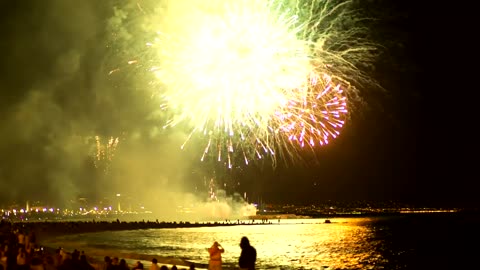 Fireworks illuminating the beach sky the sea