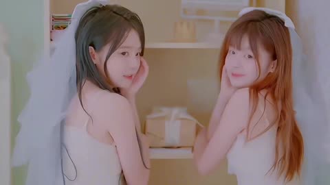 two cute girls in wedding dresses