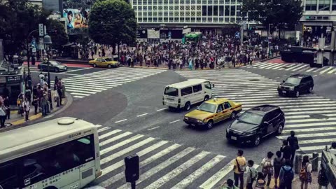 Crowds-of-people-cross-a-street-junction