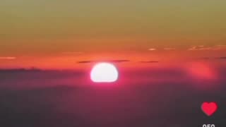 Sun Rising Out Of Clouds In Front Of The Horizon