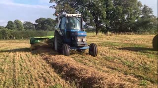 Ford 6810 tractor and John Deere 459 baler baling straw