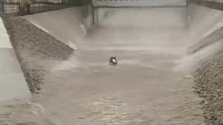 LA firefighters rescuing a flood victim