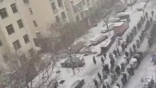 Massive line of Chinese people standing in the freezing snow to take a fake test