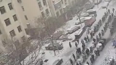 Massive line of Chinese people standing in the freezing snow to take a fake test