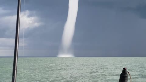 Insanely huge waterspout forms right in front of fishing boat