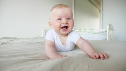 Little baby walking helped by his father