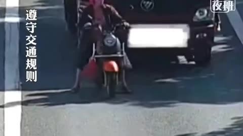 lady on scooter tries to stop cars on motor way, gets wrecked!