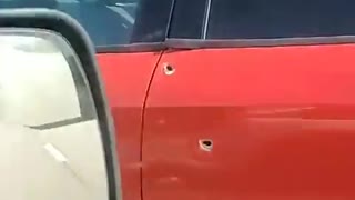 Car Riddled With Bullet Holes