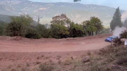 A Rally Racing with shooting Helicopter at sky