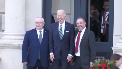 Speaker of the Irish Parliament physically moves Pedojoe into position for the photoshoot..