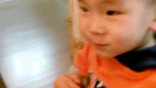 Adorable baby using chopsticks