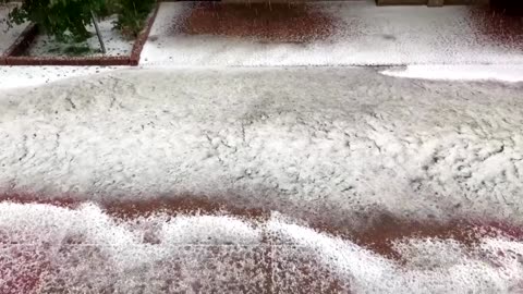 Rivers of hail flow through Boulder streets