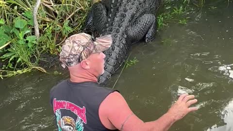 Man Jumps Out of Boat to Help Distressed Gator onto Land
