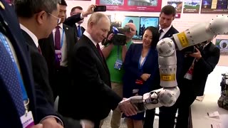 Putin shakes robotic hand at Chinese university