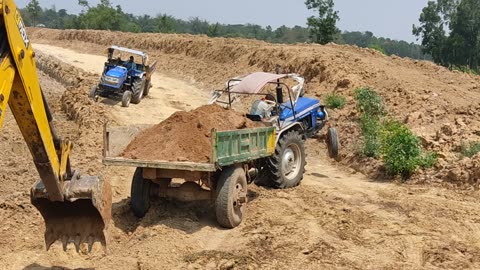 Powertrac Tractor is stuck Tractor is being pushed by JCB