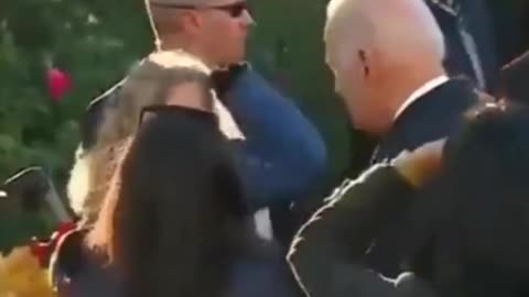 President Biden strokes little girl