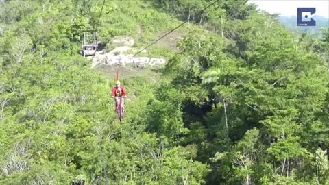 Tourists Ride Bicycle Over Zipline