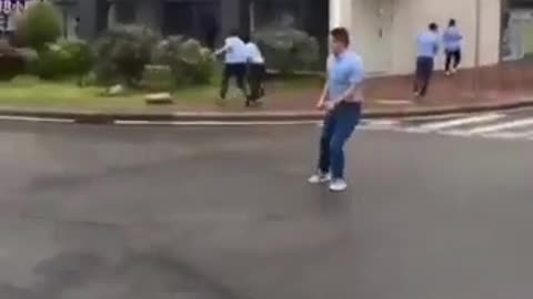 couple get blown down the street in high winds