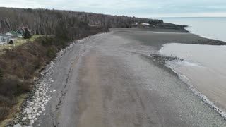 taking a flight over a stoney beach