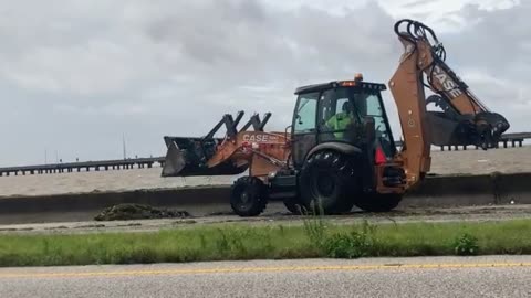 Tractor Clears Flooded Road In Mobile, AL