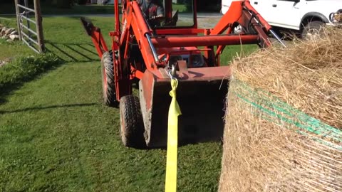 Daniel rolling the round bale over so we can pick it up with the Kubota.