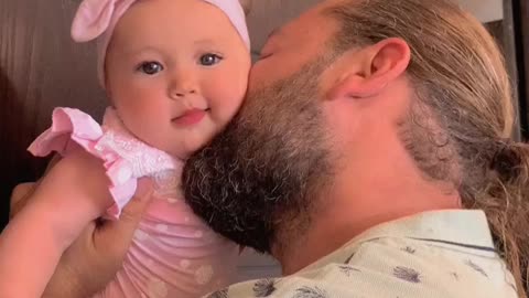 Daddy kissing baby