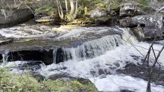 Tiny waterfall beside abandon railway