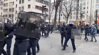 KARMA: France. Woman police officer faints as a stone is thrown at her helmet.