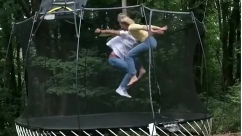 chick gets bounced over the trampoline nets