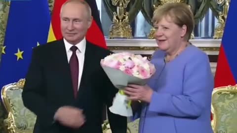Ms merkel is accepting Mr Putin's flowers
