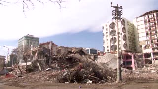 Quake damaged building collapses during demolition
