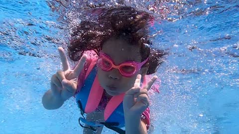 Little girl swimming under water