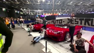 Climate activists glue themselves to sports cars