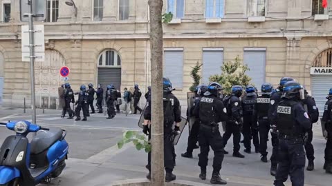 Protesters light fires, police launch tear gas in Lyon during Macron visit