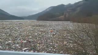 Flooded river completely fills up with garbage from landfill