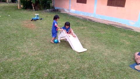 Twins on slide.