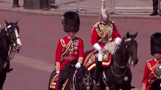 Prince Charles and William ride down Mall on horseback