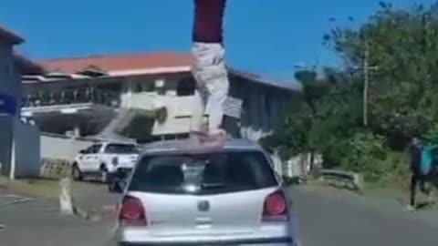 Nothing to see here just a crackhead on top of a car